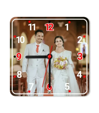 A studio front view of a square upahar18 Table clock cleanly printed with a high-resolution custom photo layout of a wedding couple, isolated on a solid white background.