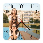 A crisp studio front view of a square upahar18 Wall clock printed with a high-definition custom photo of three happy girls stacked vertically, isolated on a solid white background.