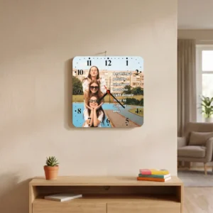 A square-shaped MDF clock from upahar18 hanging on a beige living room wall above a wooden console, featuring a printed custom photo of three female friends and an inspirational friendship quote.