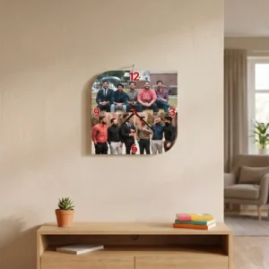 A unique square-shaped MDF clock from upahar18 hanging on a beige room wall above a wooden TV console cabinet, showing a printed custom photo collage of friends.