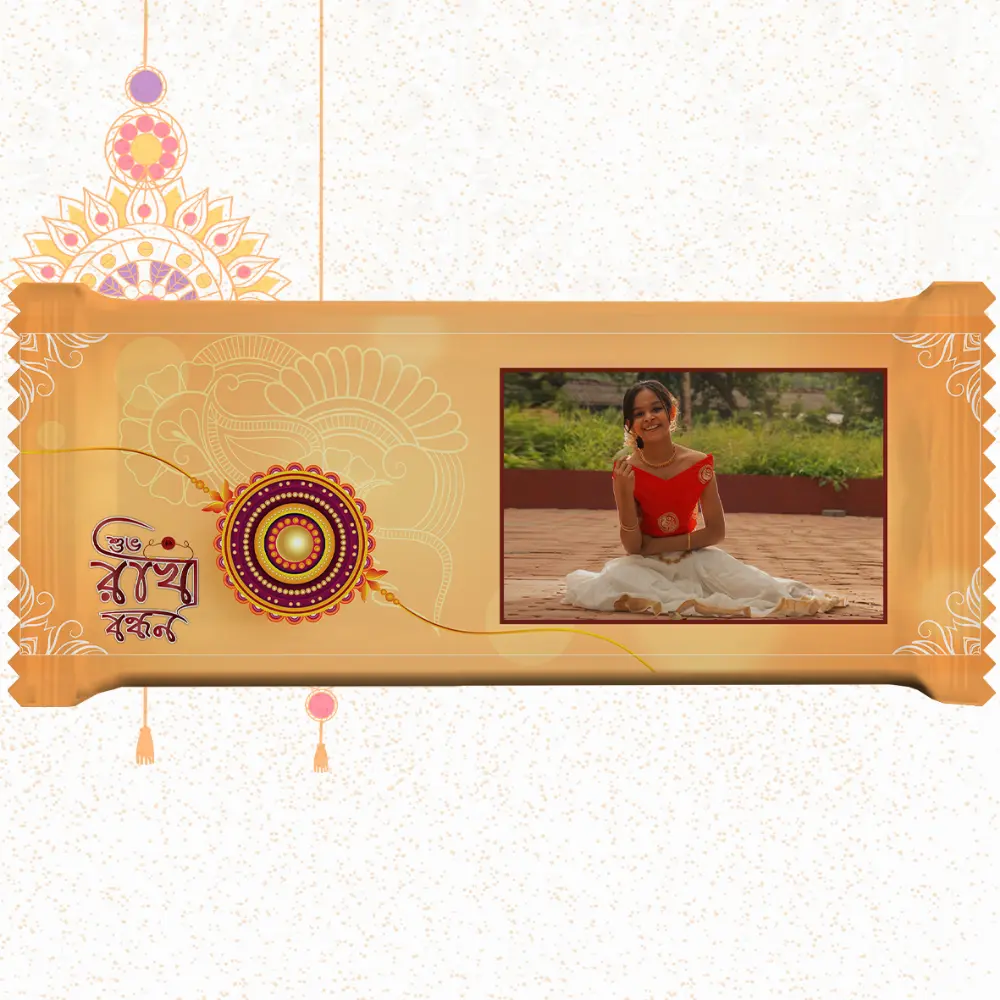 Horizontal custom Nestlé KitKat by upahar18 with a golden customize design wrapper showing a large rakhi emblem, Bengali typography, and a photo chocolate print of a smiling young girl in traditional attire.
