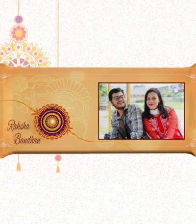 Horizontal custom Nestlé KitKat by upahar18 with a golden customize design wrapper showing a large rakhi emblem, English typography, and a photo chocolate print of a smiling brother and sister in traditional outfits.