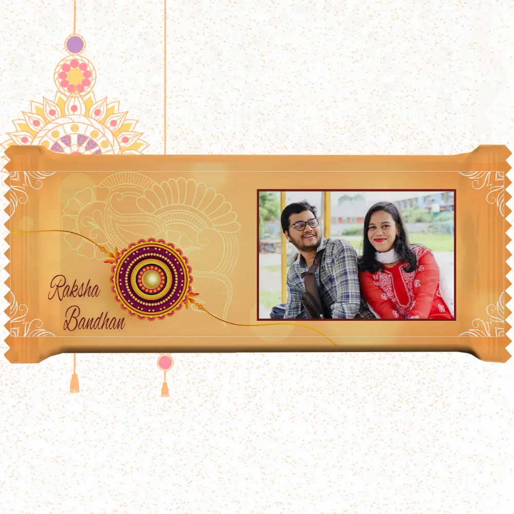 Horizontal custom Nestlé KitKat by upahar18 with a golden customize design wrapper showing a large rakhi emblem, English typography, and a photo chocolate print of a smiling brother and sister in traditional outfits.