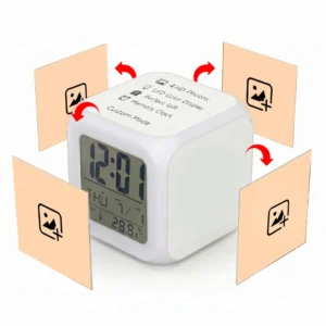 A graphic illustration detailing the customization options of the white Upahar18 personalized photo printed led alarm clock. The cube clock sits at an angle showing its digital screen and a top panel printed with the text '4 HD Photos, LED Color Display, Perfect Gift, Memory Clock, Custom Made'. Four square light-orange placeholder panels, each showing a black mountain-and-plus image icon, hover around the sides with curved red arrows pointing toward the clock faces, illustrating that up to four custom photos can be printed on its different sides.