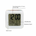 A close-up user interface diagram of the front LCD display screen of the Upahar18 personalized photo printed led alarm clock. Thin black pointer lines extend outward to English text labels explaining each section of the digital interface: the top reads 'Time display/system of 12 hours, 24 hours a day' pointing to the 12:00 time digits, the bottom left reads 'Week showed' pointing to 'THU', the middle right reads 'The date shown' pointing to '1/1', and the bottom right reads 'Temperature Display' pointing to '28.6°C' next to a small thermometer graphic.
