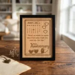 An upahar18 personalized custom engraved frame displayed on a rustic wooden table in a well-lit cozy room, showcasing the premium finish of the MDF wooden anniversary memento.