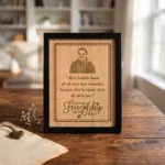 An upahar18 personalized custom engraved frame for friendship day placed on a rustic wooden table in a brightly lit cozy room setting, displaying the premium wood engraving finish of the MDF memento plaque.
